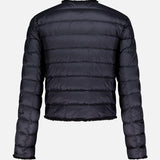 The MONCLER Fleurs Bouclé Trim Jacket is shown from the back, highlighting its black color, horizontal stitching, slightly cropped fit, and down-filled puffer warmth against a plain white background.