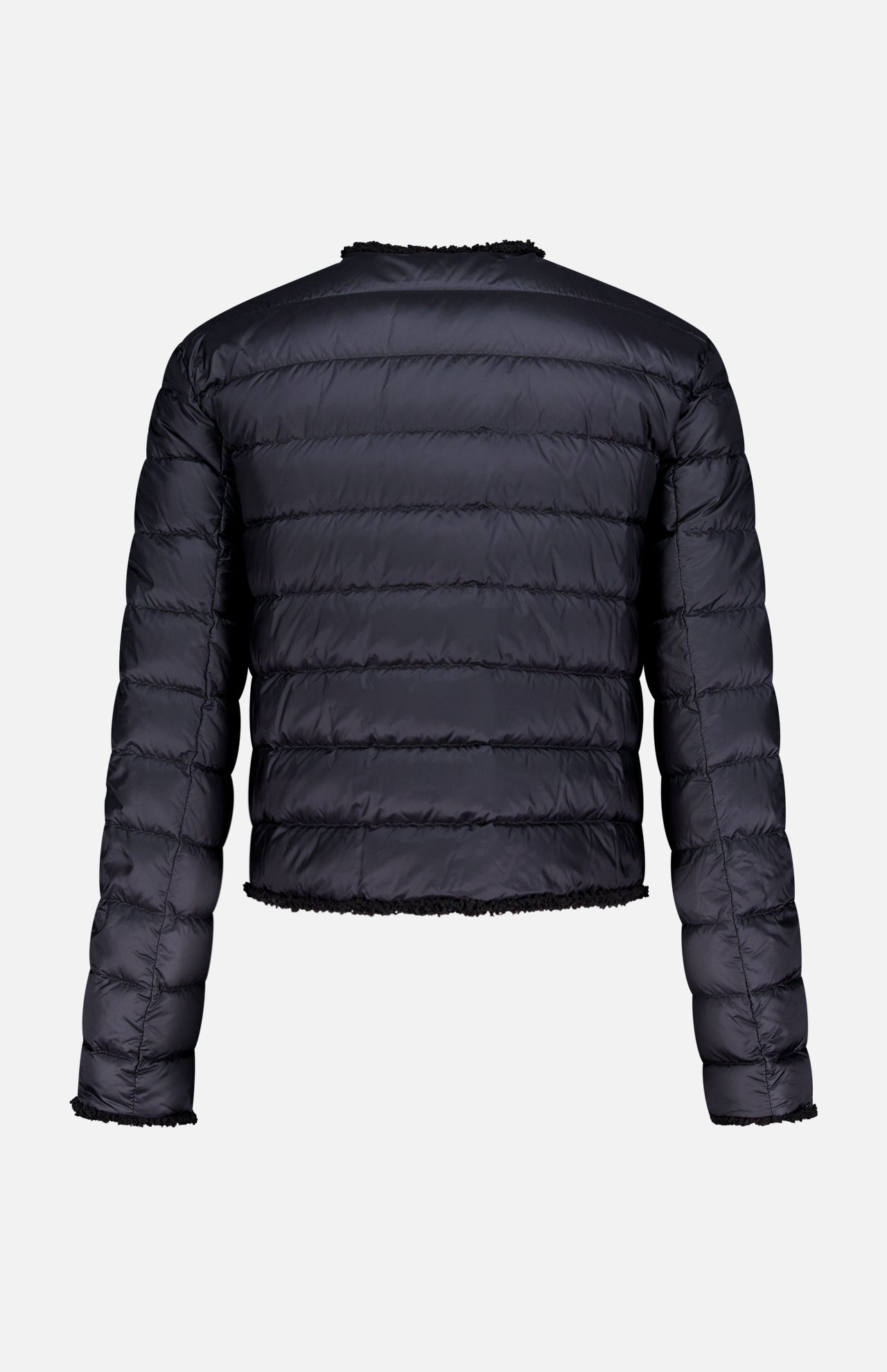 The MONCLER Fleurs Bouclé Trim Jacket is shown from the back, highlighting its black color, horizontal stitching, slightly cropped fit, and down-filled puffer warmth against a plain white background.