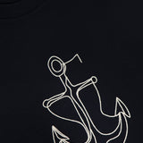 Close-up of the MONCLER Anchor Graphic Short Sleeve T-shirt in black, featuring a white embroidered anchor and monogram at the bottom right—an ideal pick for fans of nautical-inspired designer tees.