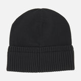 The MONCLER Ribbed Logo Beanie is a plain black ribbed wool hat featuring a folded ribbed brim, shown against a white background.
