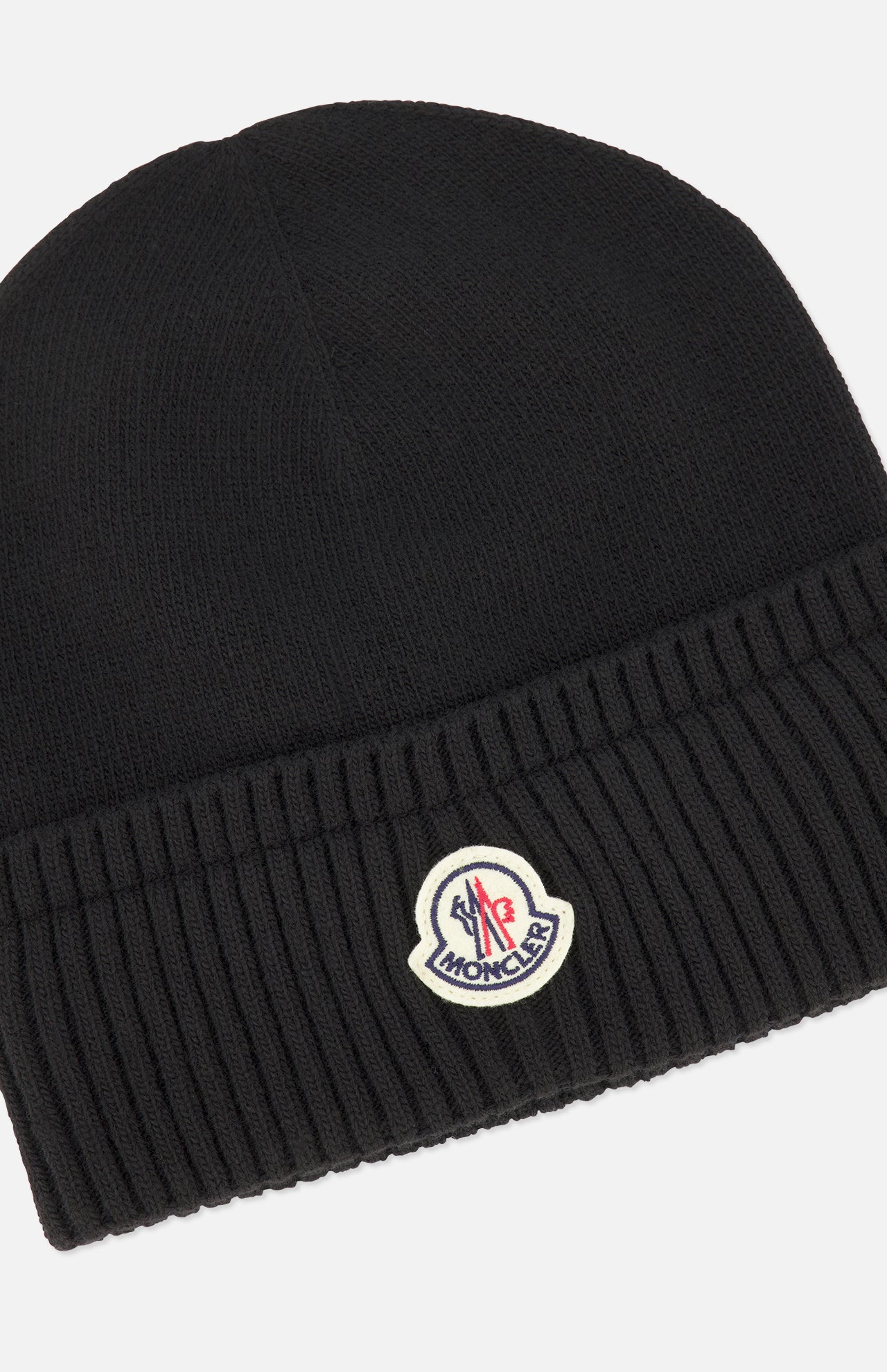 A black Ribbed Logo Beanie by MONCLER, this wool hat features a fold-over cuff and a small logo patch centered on the front.