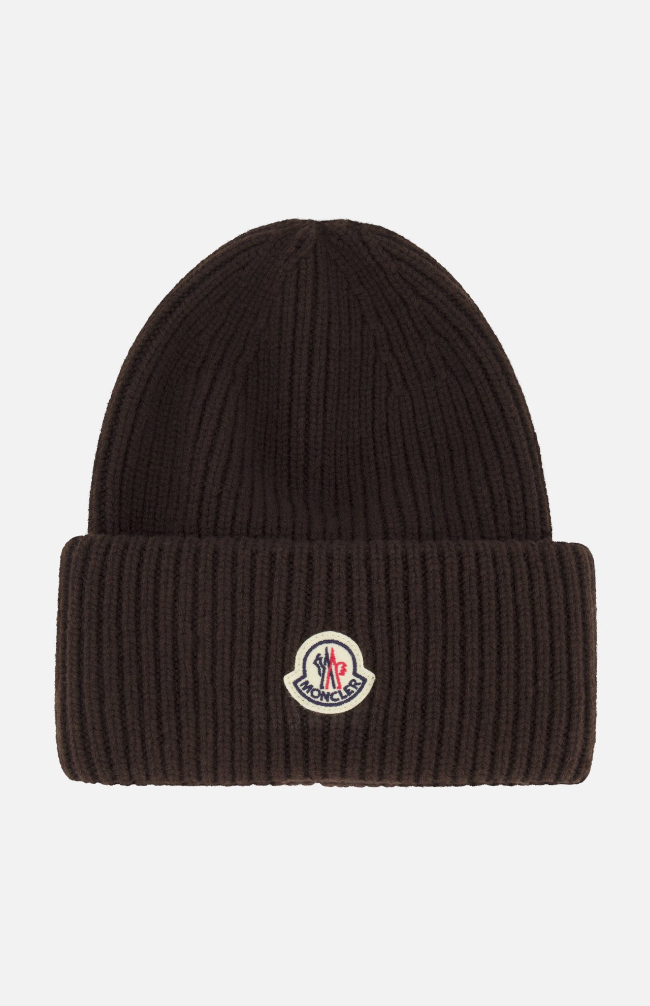 A dark brown MONCLER Contrast Logo Beanie crafted from virgin wool in a ribbed design, featuring a folded brim and a small contrast Moncler logo patch at the front center.
