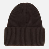 A MONCLER Contrast Logo Beanie in dark brown, crafted from virgin wool with a ribbed design and a folded brim, displayed against a plain white background.