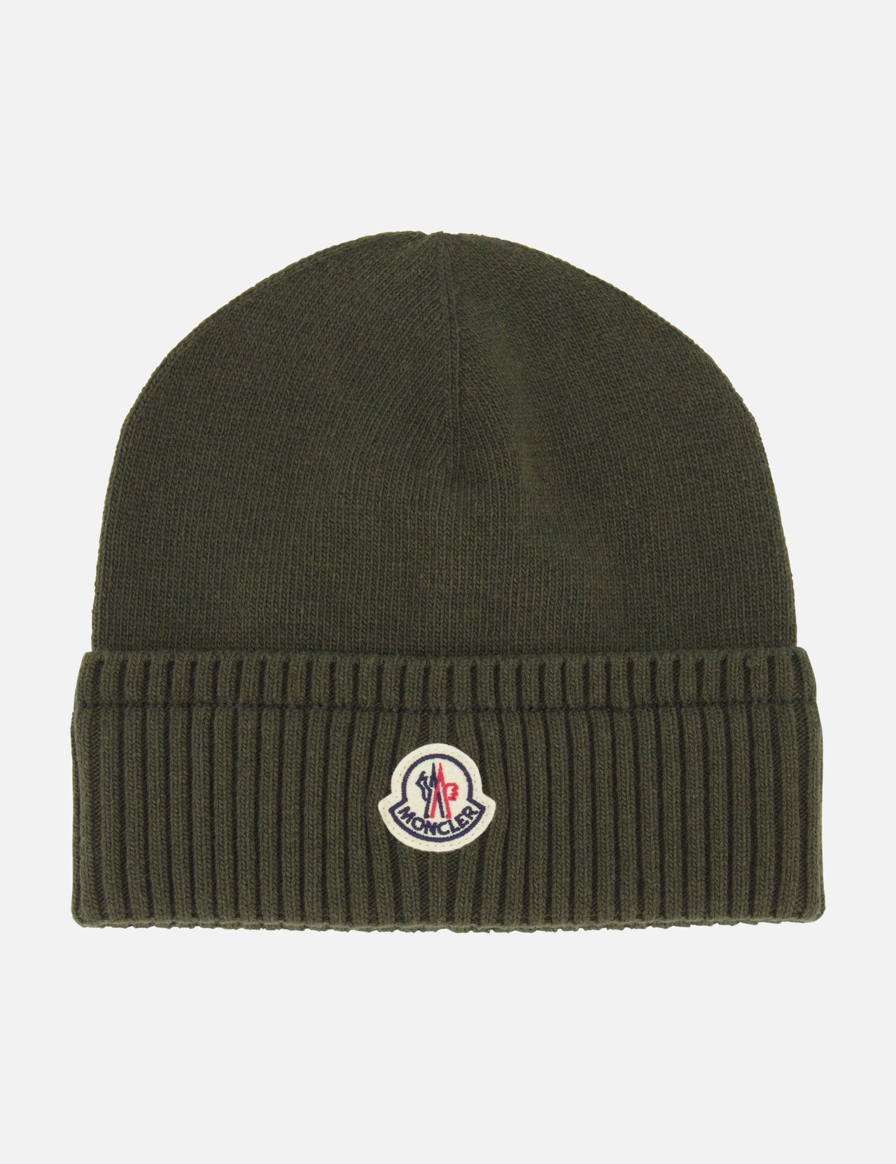The MONCLER Ribbed Logo Beanie is a dark green knit hat crafted from luxurious virgin wool, featuring a ribbed texture, folded brim, and a small Moncler logo patch centered on the front of the fold.