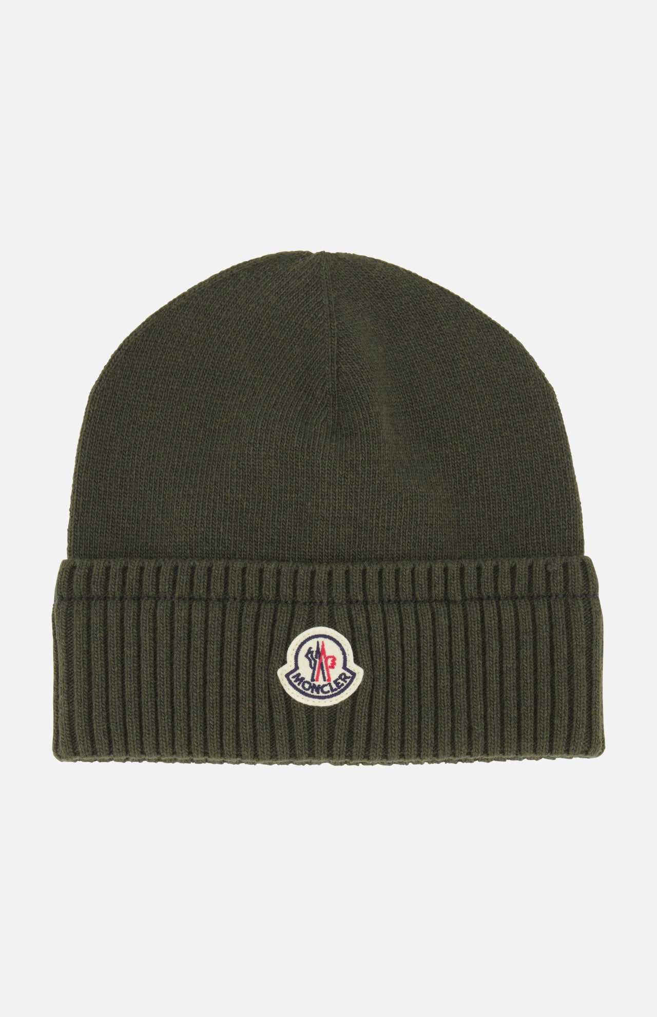 The MONCLER Ribbed Logo Beanie is a dark green knit hat crafted from luxurious virgin wool, featuring a ribbed texture, folded brim, and a small Moncler logo patch centered on the front of the fold.
