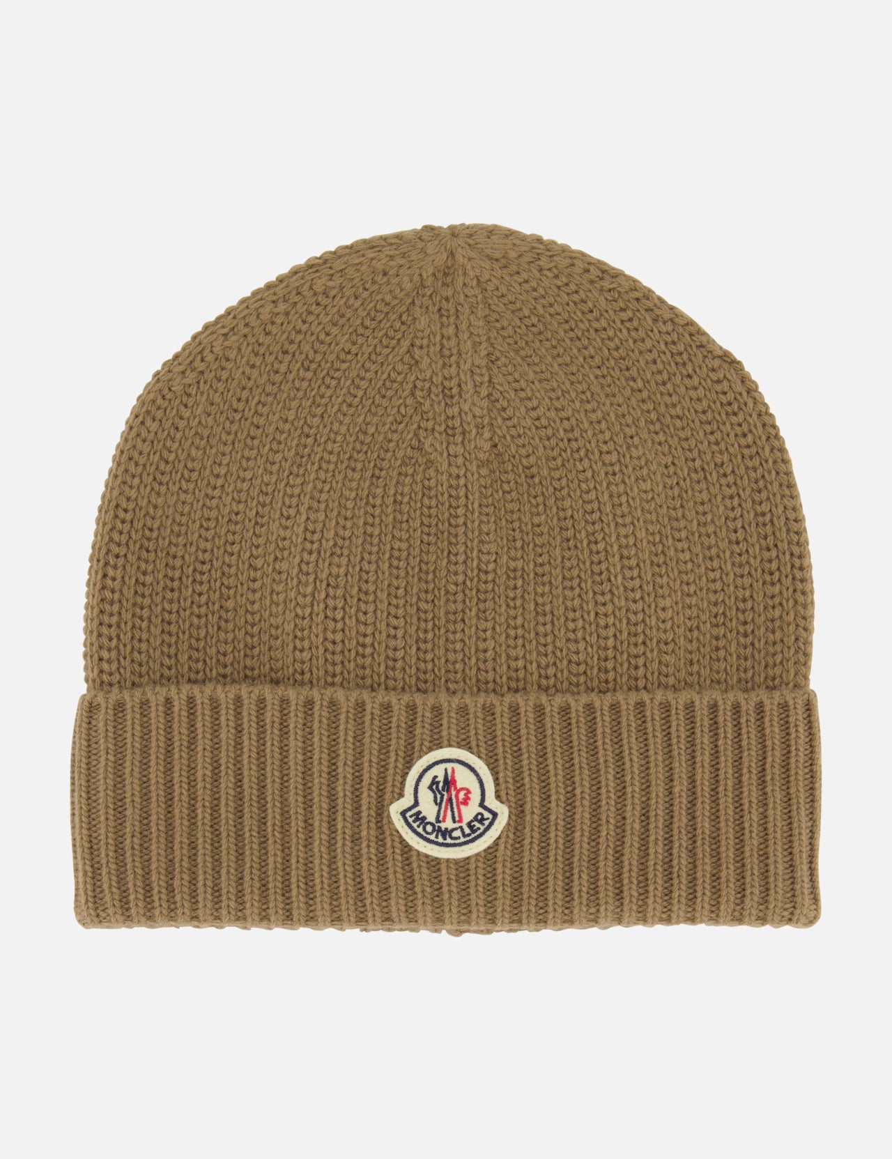 The MONCLER Ribbed Logo Beanie is a brown knit beanie with a folded cuff, featuring the signature Moncler patch on the front center. This stylish accessory is showcased against a plain white background.