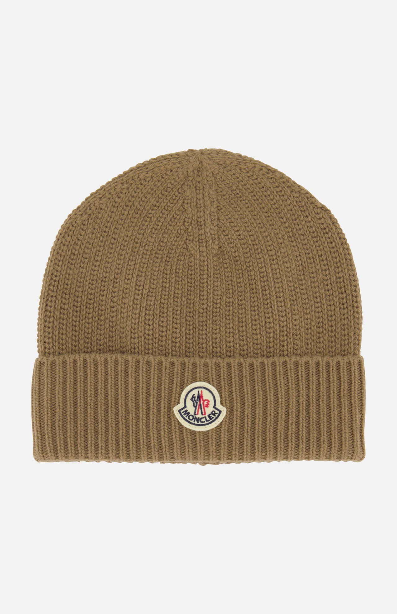The MONCLER Ribbed Logo Beanie is a brown knit beanie with a folded cuff, featuring the signature Moncler patch on the front center. This stylish accessory is showcased against a plain white background.