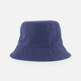 The MONCLER Reversible Bucket Hat features a deep blue cotton design with a slightly flared brim, shown against a white background.