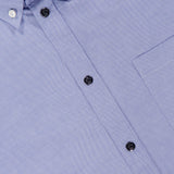Close-up of the MONCLER Cotton Button Up Shirt in light blue with a front pocket, white stitching, black buttons, visible collar, and a partial MONCLER label at the top left for authenticity.