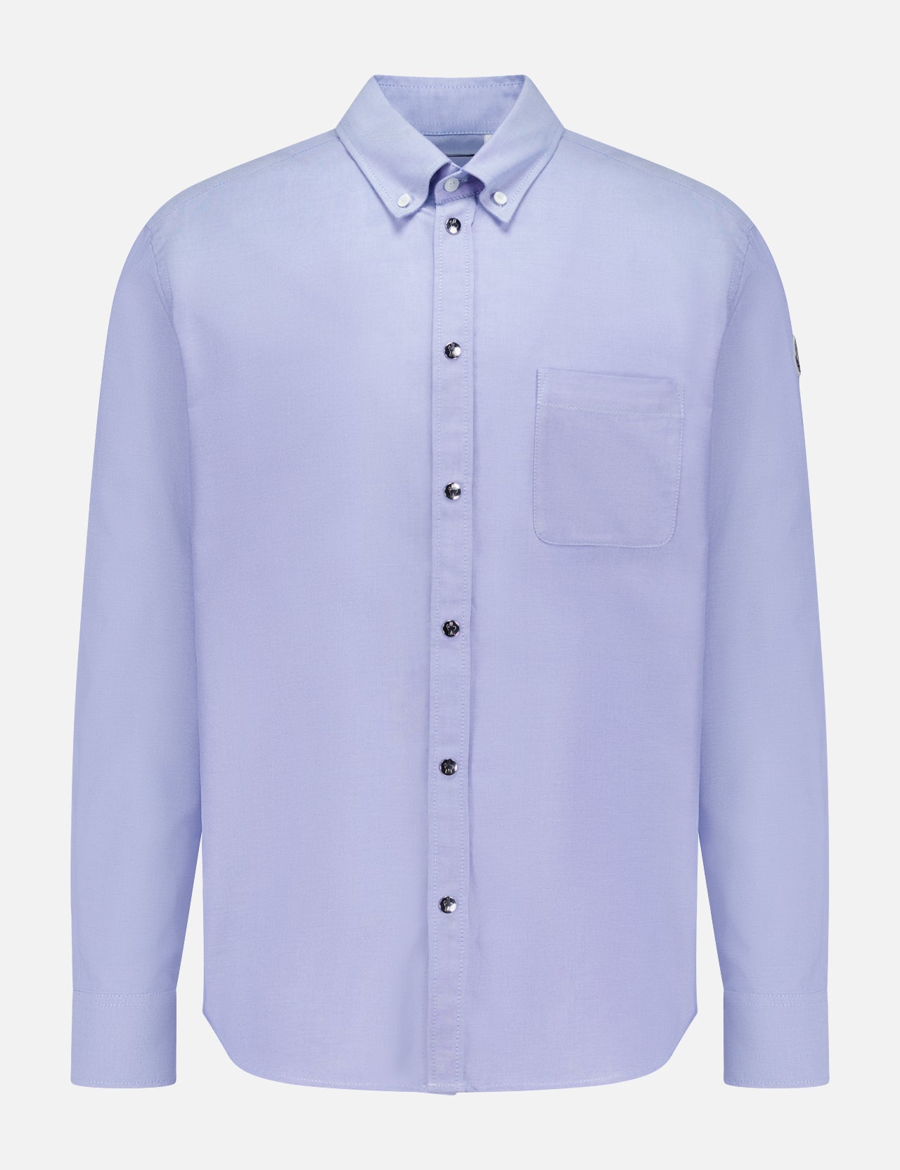 The MONCLER Cotton Button Up Shirt is a light blue, long-sleeve cotton shirt with a single chest pocket and buttoned collar, shown on a white background.