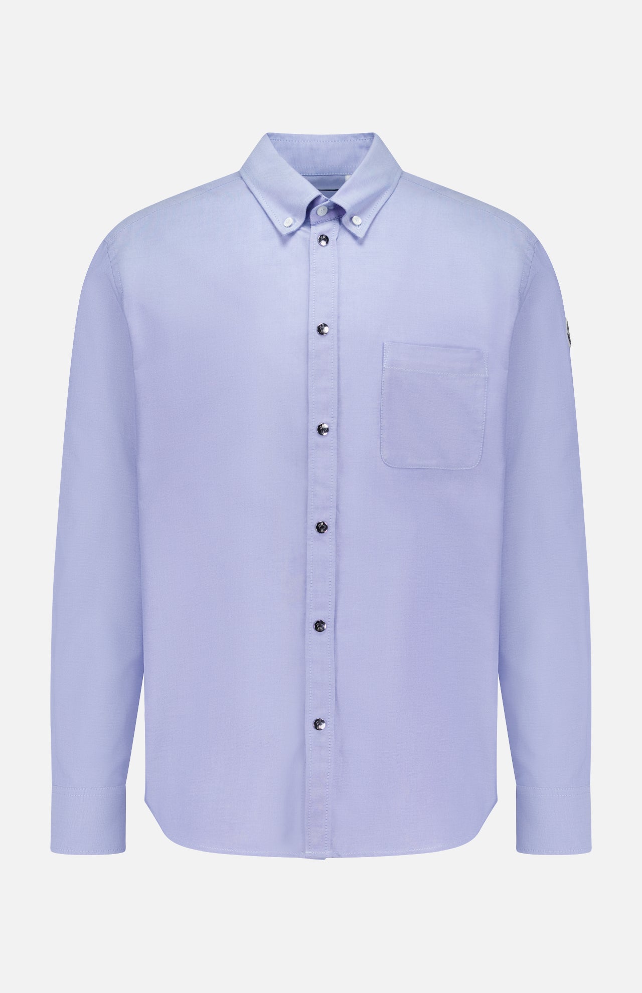 The MONCLER Cotton Button Up Shirt is a light blue, long-sleeve cotton shirt with a single chest pocket and buttoned collar, shown on a white background.