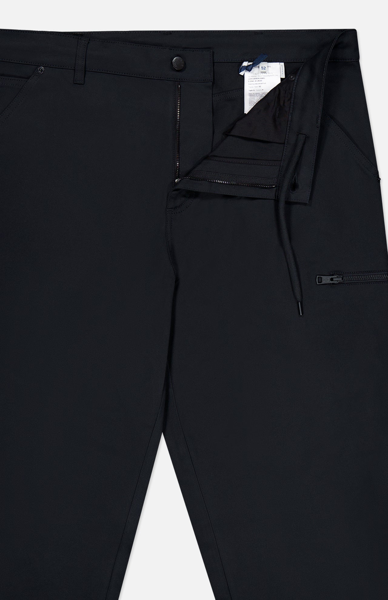 A pair of MONCLER Zip Pocket Stretch Pants in black is shown from the waist down, with the front partially unzipped to highlight the zipper, button closure, drawstring, and a visible inner tag. This stretch design also includes a small zip pocket on the right side.