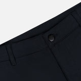 Close-up of the waistband and top front section of the MONCLER Zip Pocket Stretch Pant in black, featuring a button closure, belt loops, and visible stitching against a light gray background.