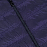 Close-up of the MONCLER Ceze Striped Reversible Jacket in dark purple, showcasing a diagonal black zipper and horizontal stitching on the fabric.