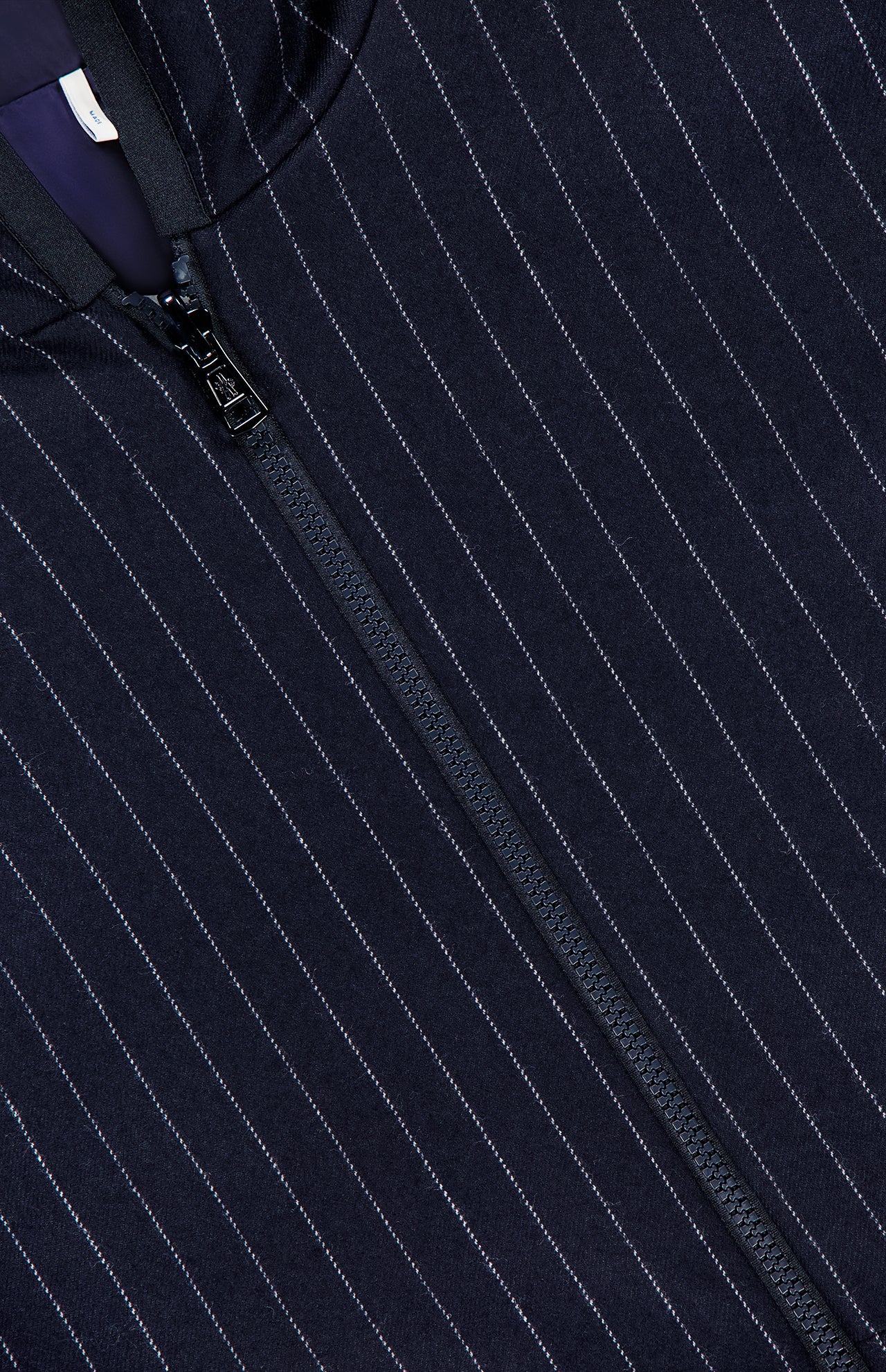 Close-up of the MONCLER Ceze Striped Reversible Jacket in navy, featuring thin white vertical pinstripes and a black center zipper.
