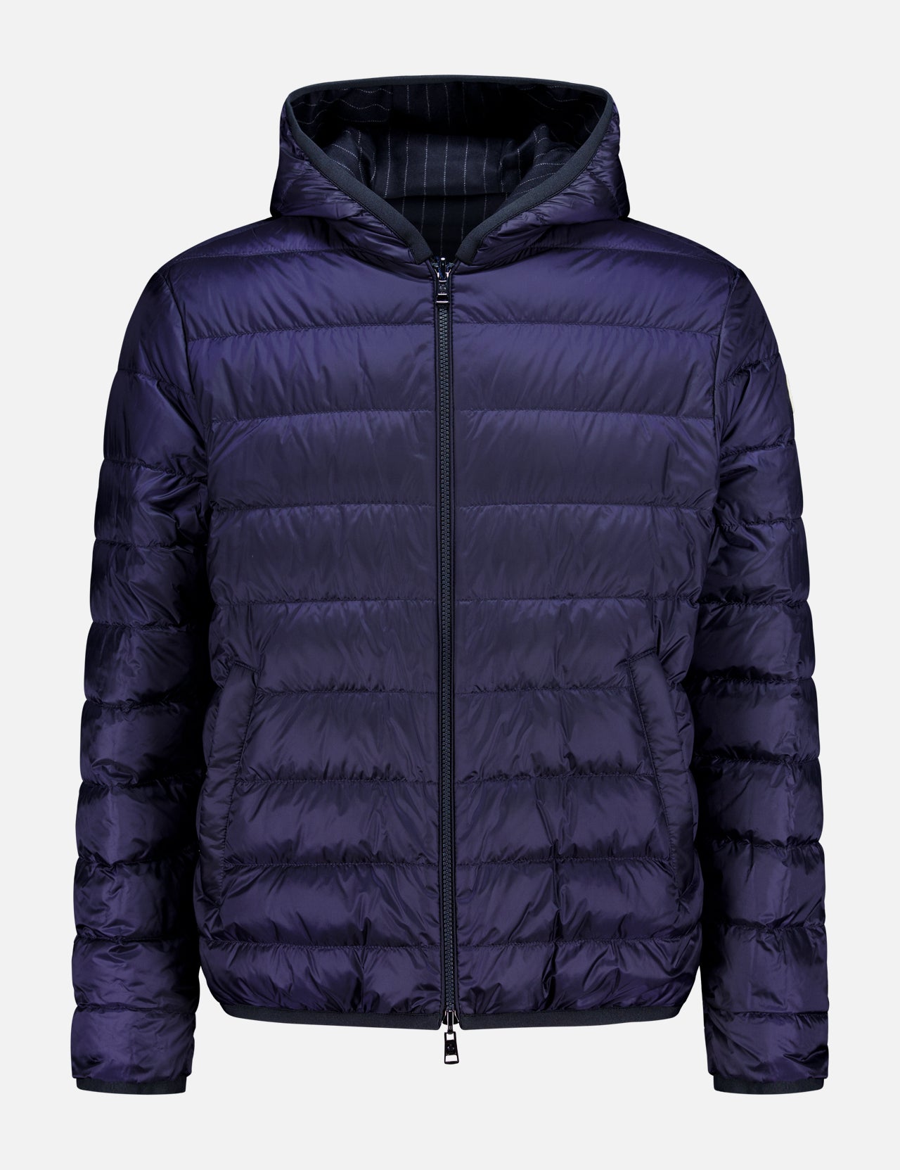 The MONCLER Ceze Striped Reversible Jacket features a dark purple exterior, black pinstriped interior, front zipper, horizontal quilting, side pockets, and an attached hood. The jacket is shown against a plain white background.