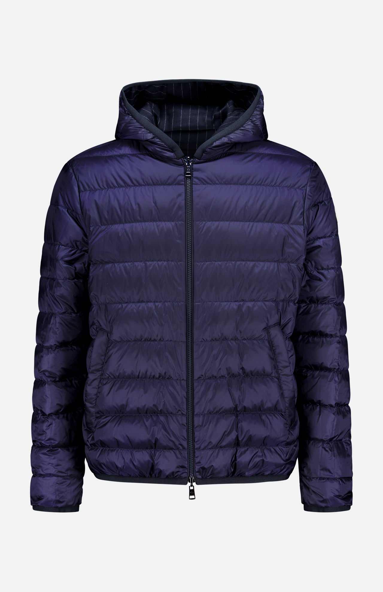 The MONCLER Ceze Striped Reversible Jacket features a dark purple exterior, black pinstriped interior, front zipper, horizontal quilting, side pockets, and an attached hood. The jacket is shown against a plain white background.