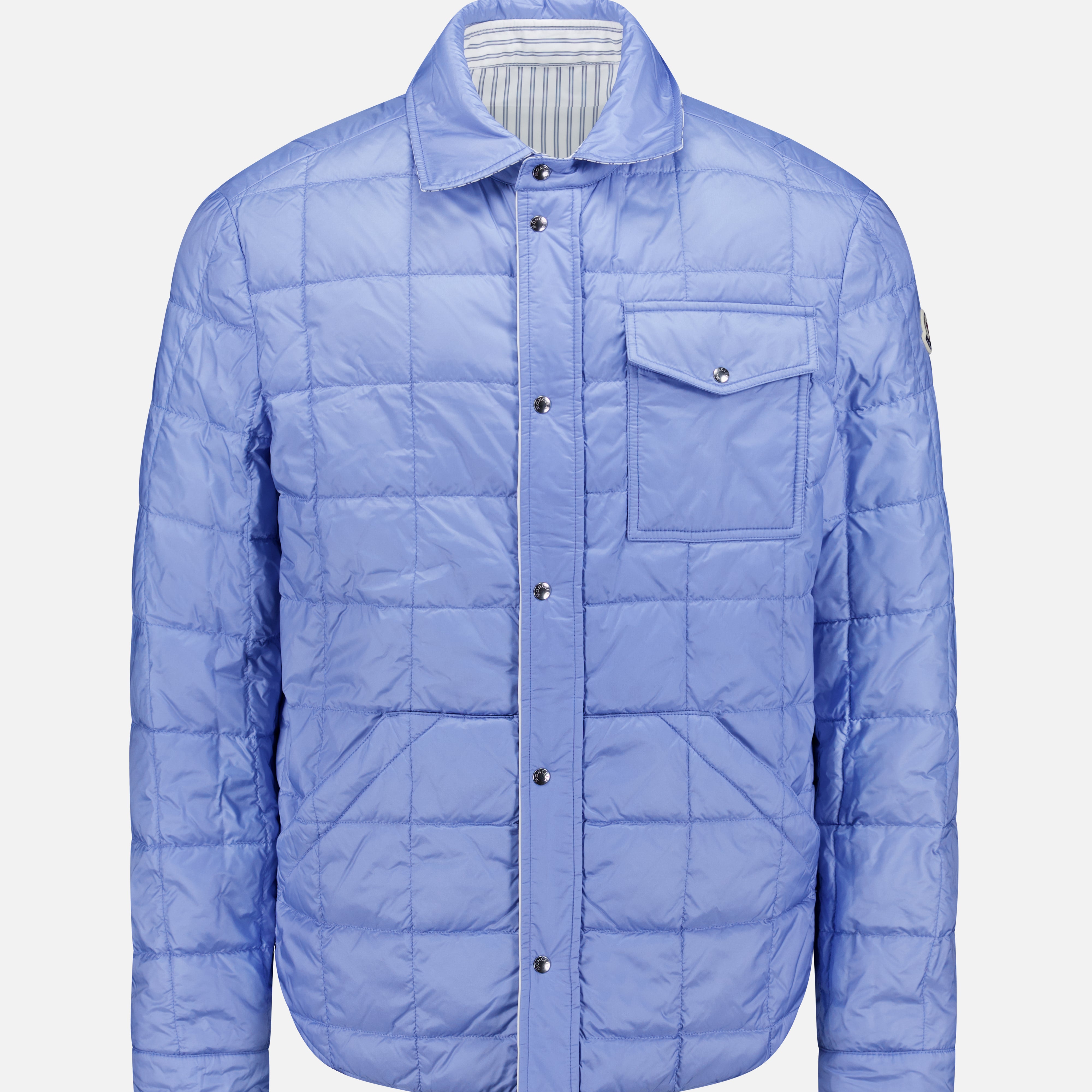 The MONCLER Reversible Crescent Shirt Jacket is a light blue men's outerwear with snap buttons, a collar, long sleeves, a chest pocket, subtle grid stitching, and a slight sheen.