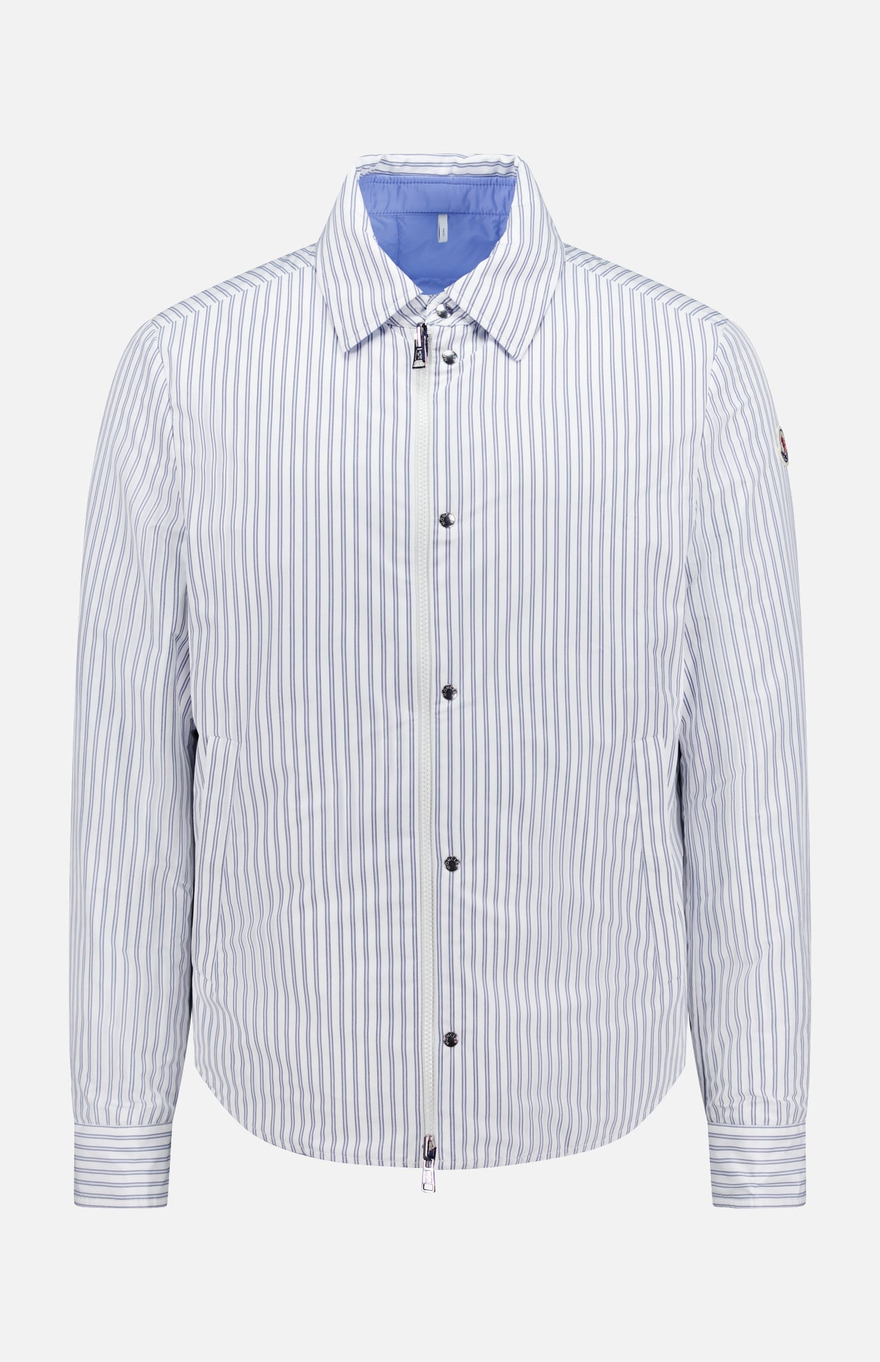 The MONCLER Reversible Crescent Shirt Jacket for men features light blue and white vertical stripes, a collar, long sleeves, front zipper, snap buttons, light blue lining, and a relaxed fit—ideal for stylish outerwear.