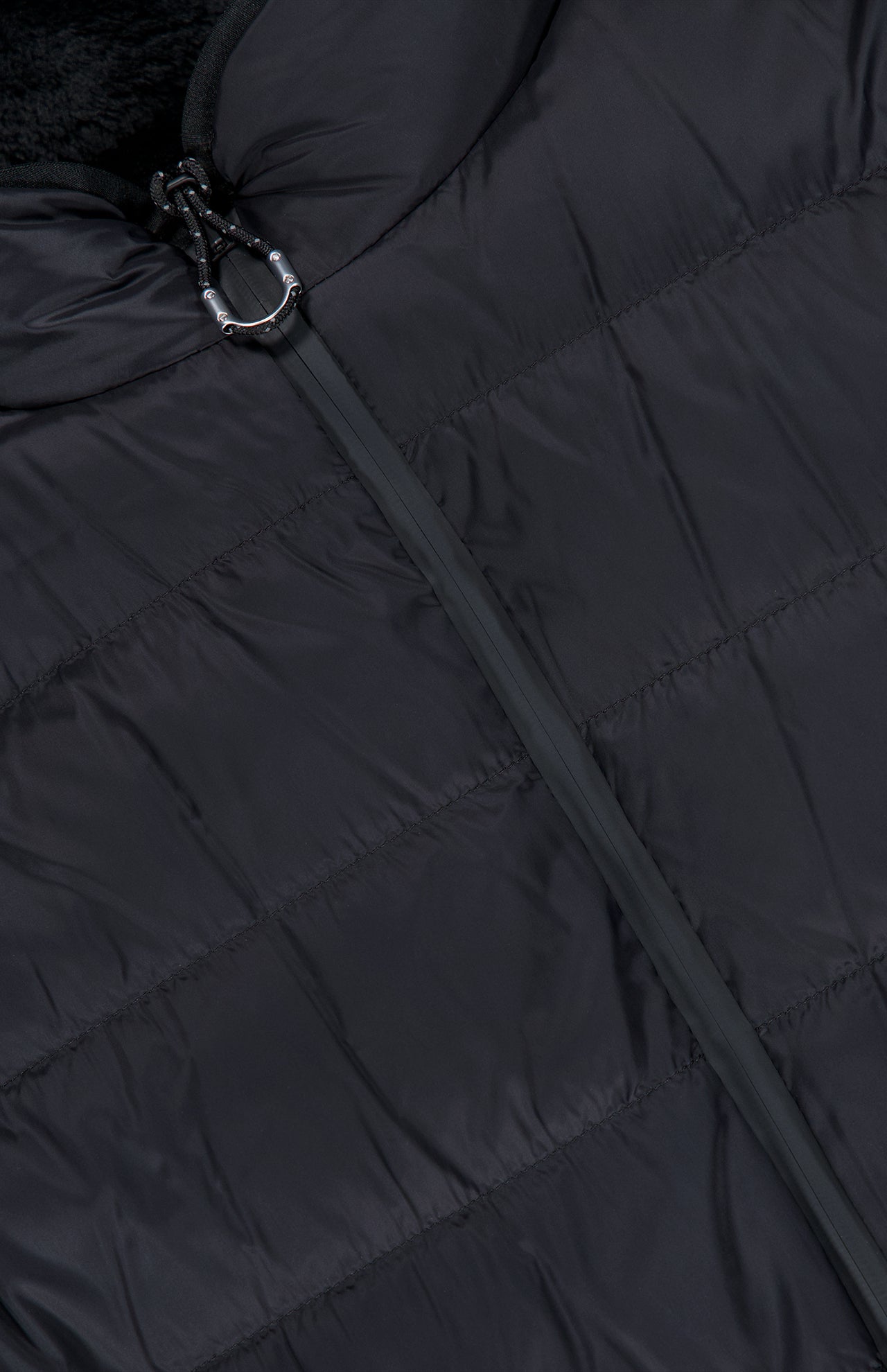 Close-up of the MONCLER Fleeced Chest Pocket Vest, a true cold-weather staple, featuring horizontal stitching, a smooth zipper partially closed, and a small metallic ring attached to the zipper pull.