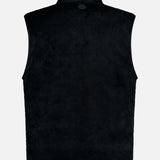 The MONCLER Fleeced Chest Pocket Vest is pictured from the back against a light gray background. This sleeveless black vest features a high collar and a soft, fuzzy texture, making it an essential cold-weather staple for your outerwear collection.