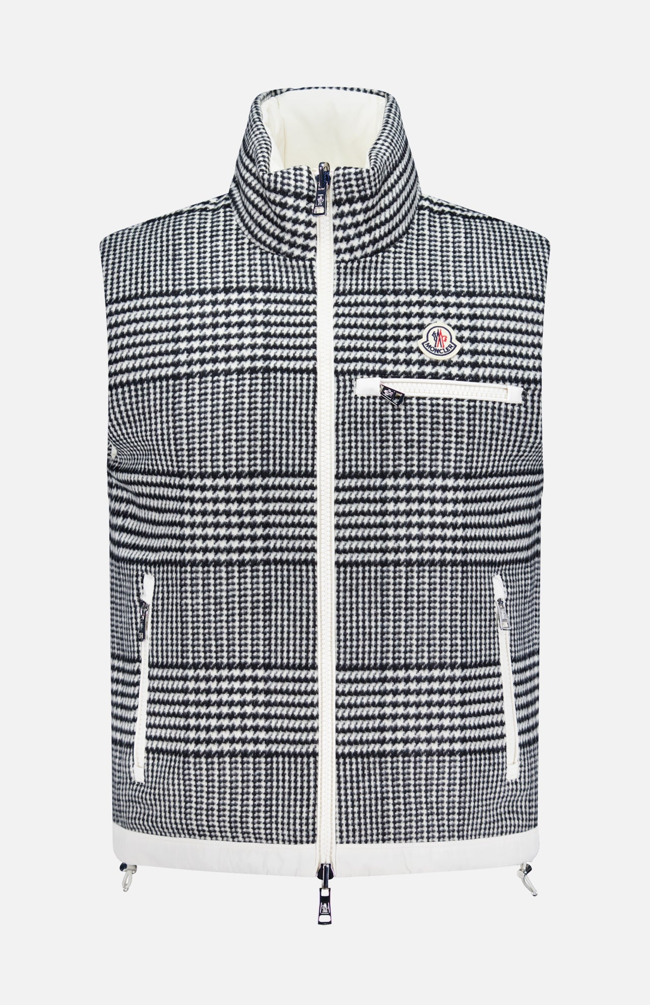 The MONCLER Gienah Houndstooth Reversible Vest features a black and white houndstooth pattern, high collar, front zipper, three white zippered pockets, chest logo patch, and offers stylish warmth.