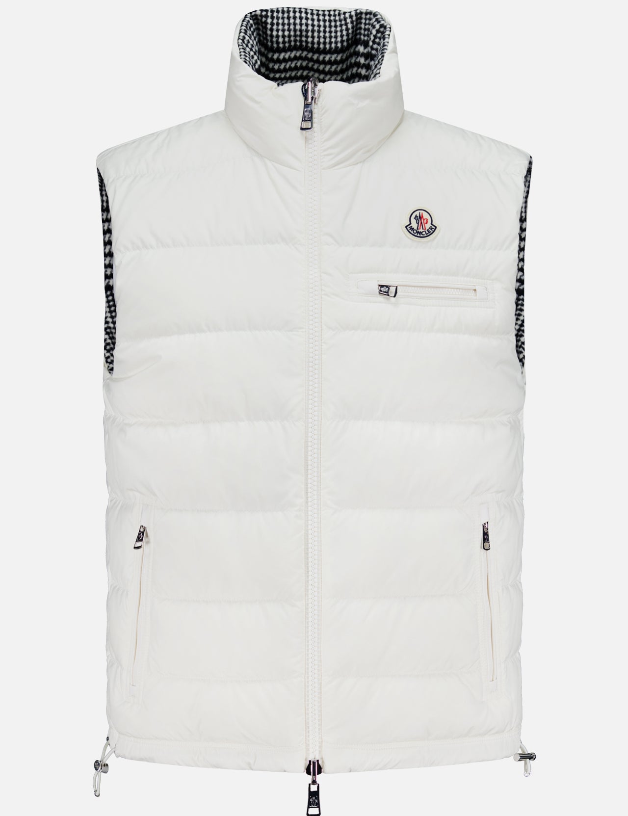 The MONCLER Gienah Houndstooth Reversible Vest is a white down-insulated vest with a high collar, front zipper, zippered chest and side pockets, a small chest logo, and a black-and-white checkered inner lining.