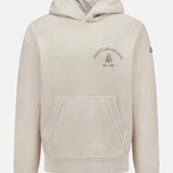 The MONCLER Hoodie Logo Sweatshirt is a beige pullover with a hood, front pocket, Archive text and emblem on the chest, and signature logo patch detailing on the left sleeve.