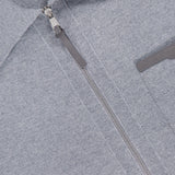 Close-up of the MONCLER Knit Zip Up Overshirt in light gray, featuring a silver zipper, textured fabric, partial chest pocket, and visible brand label inside the collar.