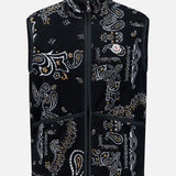 The MONCLER Reversible Paisley Fleece Vest features a black, white, and tan paisley pattern in a sleeveless teddy fleece design. It includes a front zipper closure, high collar, two large front pockets, and is finished with the Moncler logo patch on the left chest. Offering both style and versatility, this standout vest can be worn on either side.