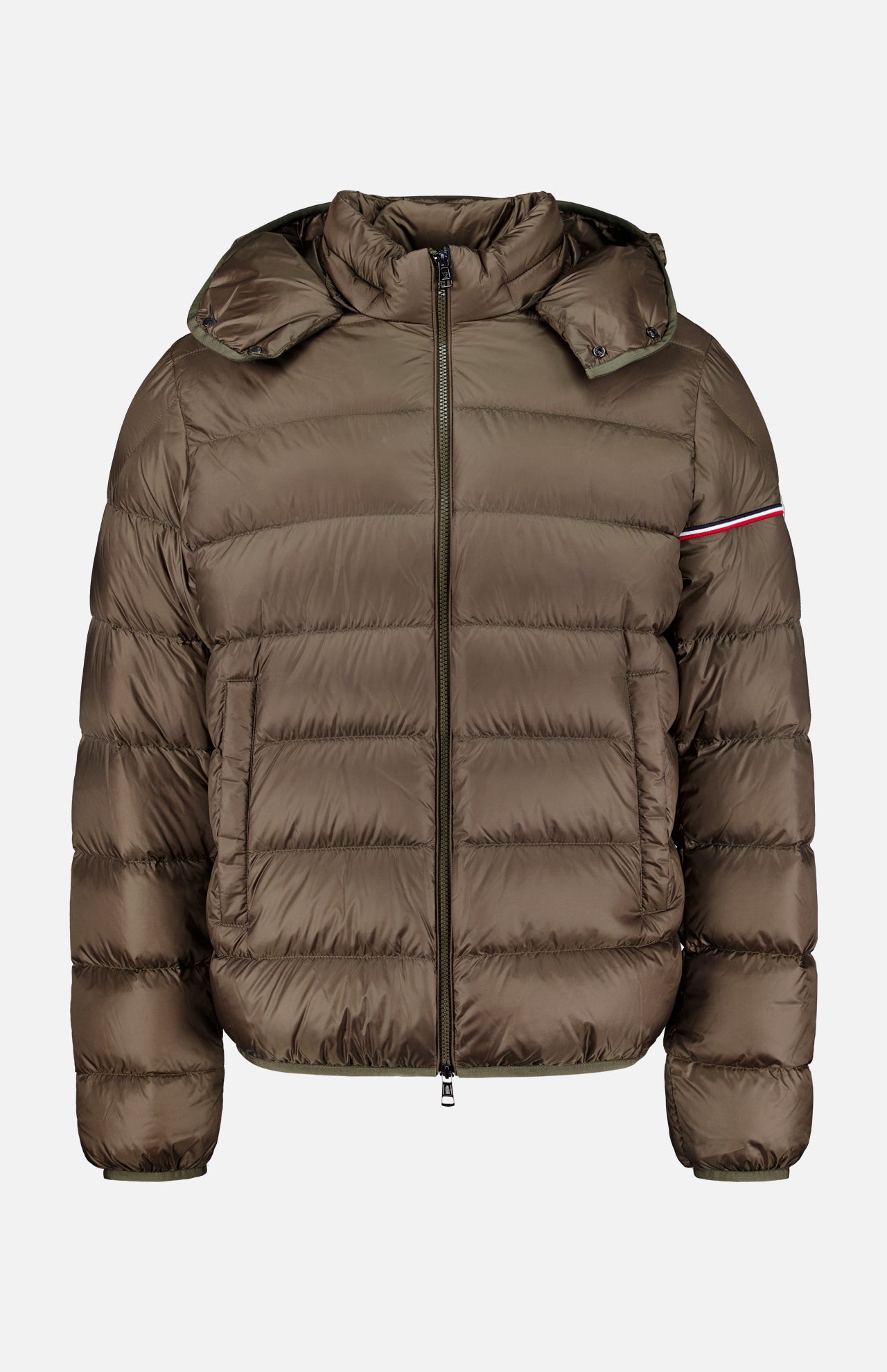The Ravenlock Removable Hood Puffer Jacket by MONCLER is a brown down jacket featuring a hood, front zipper closure, horizontal quilting, and a subtle red and white stripe detail on the upper left sleeve. Crafted from lightweight nylon for comfort and versatility.