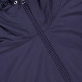 Close-up of the MONCLER Sassiere Logo Hood Jacket in navy, showcasing a central zipper and black drawstrings with metal eyelets at the hood for a classic cold-weather look.