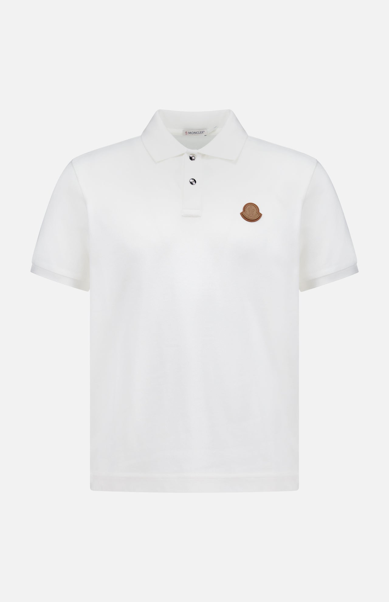 A MONCLER Short Sleeve Cotton Polo Shirt in plain white, featuring a collar, two buttons, and a small brown circular logo on the left chest.