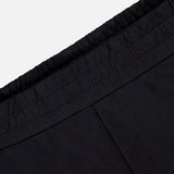 Close-up of the waistband on MONCLER Zip Pocket Drawstring Shorts, featuring an elastic gathered edge and crafted from double face cotton, shown against a plain light background.