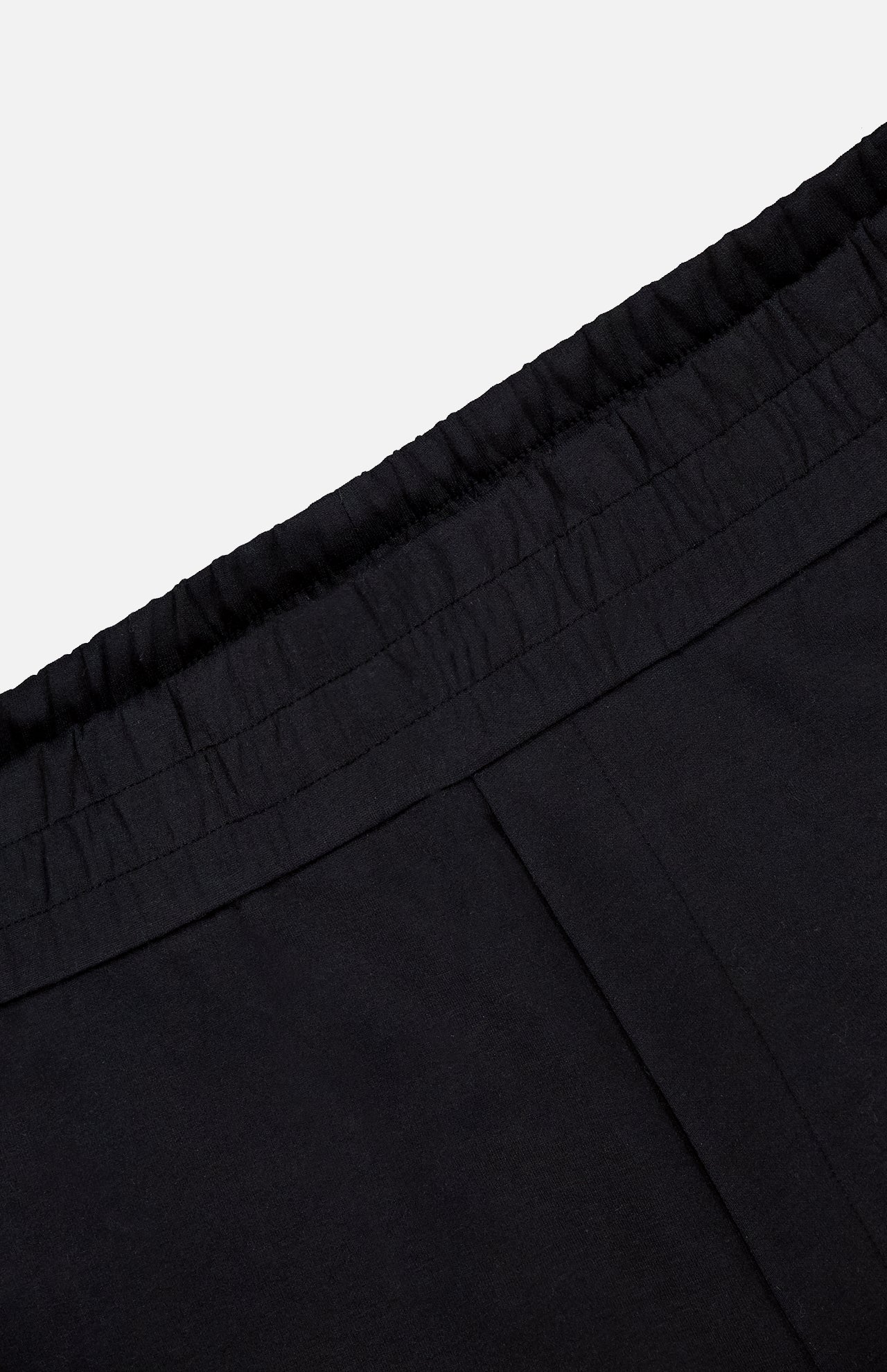 Close-up of the waistband on MONCLER Zip Pocket Drawstring Shorts, featuring an elastic gathered edge and crafted from double face cotton, shown against a plain light background.