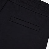 Close-up of MONCLER Zip Pocket Drawstring Shorts in black, made from double face cotton, featuring an elastic waistband and a single zip back pocket, photographed against a plain white background.