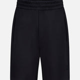 MONCLER Zip Pocket Drawstring Shorts in black, made from double-face cotton with an elastic waistband and zippered side pockets, shown on a plain white background.