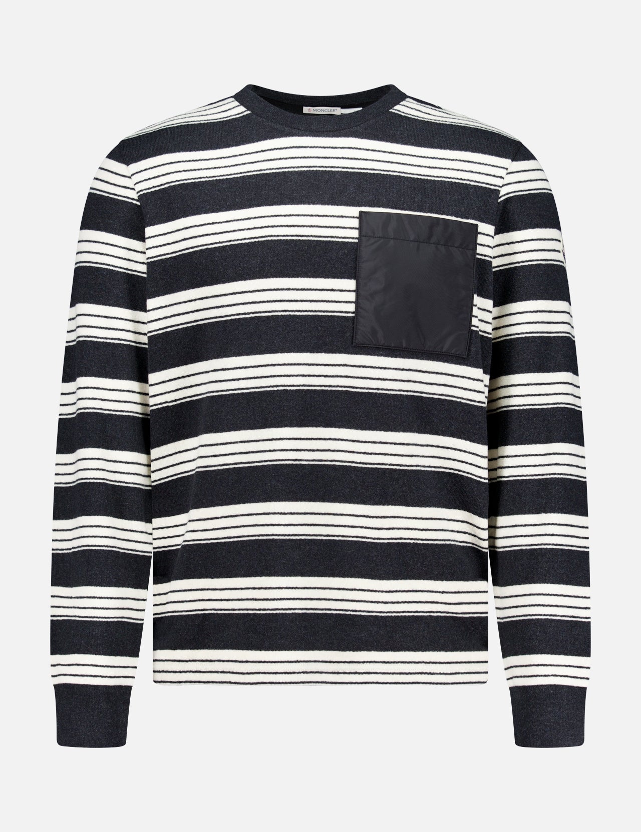Introducing the MONCLER Striped Long Sleeve T-Shirt—a stylish designer piece showcasing classic black and white horizontal stripes, a comfortable round neck, and a solid black chest pocket on the left side. Perfect for adding elevated flair to your everyday outerwear collection.