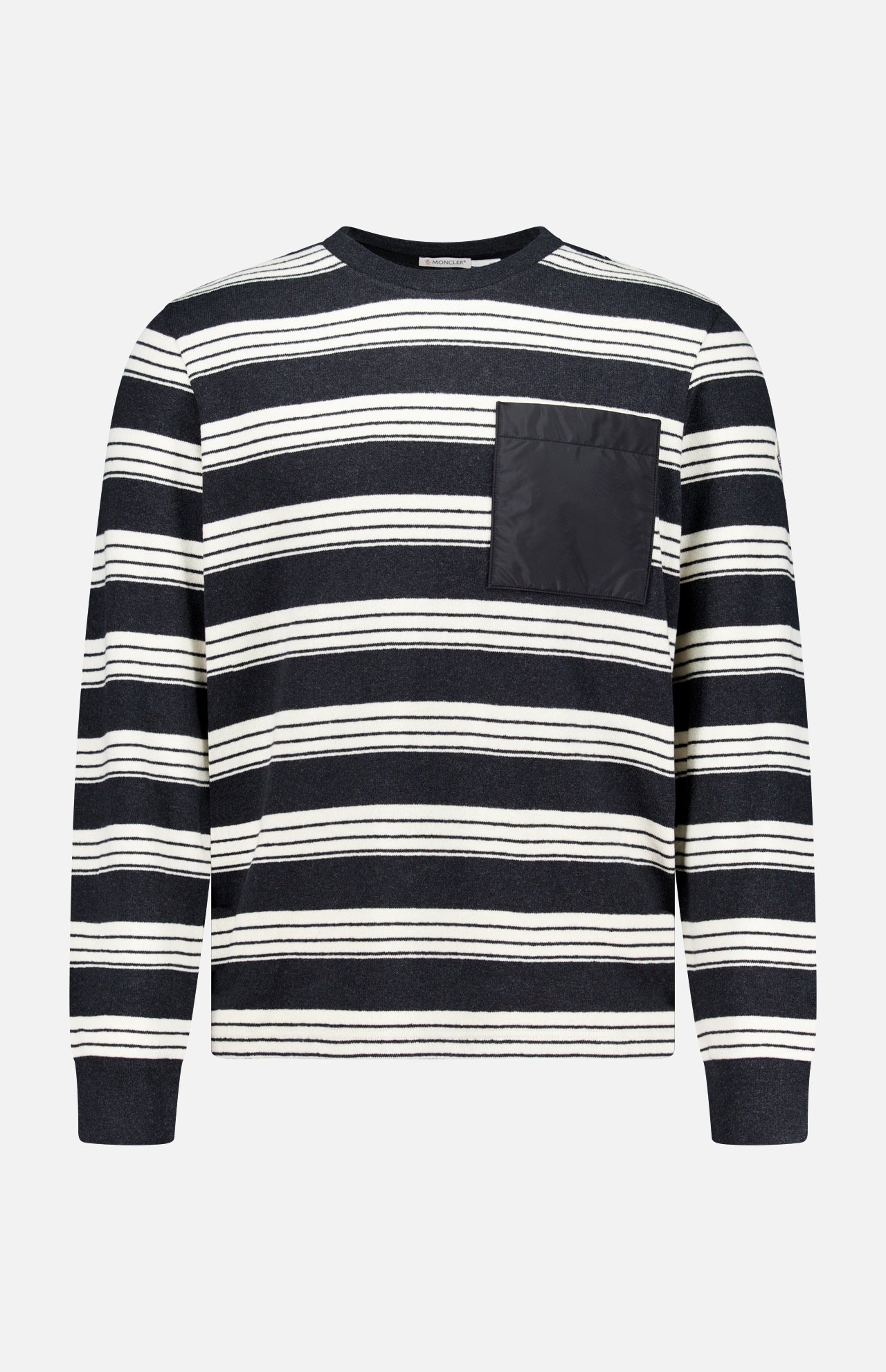 Introducing the MONCLER Striped Long Sleeve T-Shirt—a stylish designer piece showcasing classic black and white horizontal stripes, a comfortable round neck, and a solid black chest pocket on the left side. Perfect for adding elevated flair to your everyday outerwear collection.