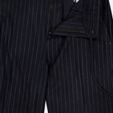 MONCLER Striped Drawstring Trousers in navy blue feature belt loops, a drawstring waist for comfort, a partially open zipper and button fly, plus visible waistband and inner tag. Crafted from wool with a pinstripe pattern.