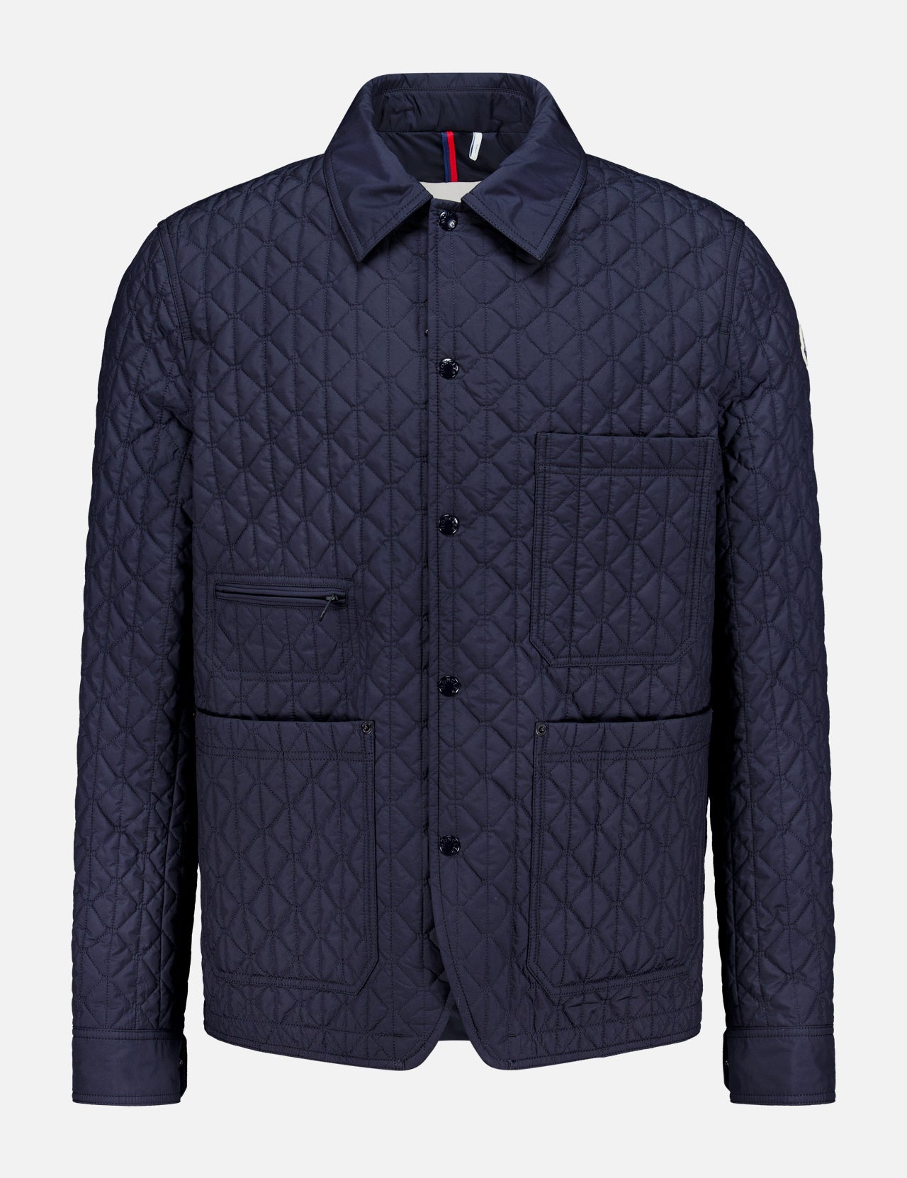 Theoline Quilted Overshirt by MONCLER features a navy quilted design with a pointed collar, button front, two chest pockets, and two hip pockets—a must-have for men’s outerwear.