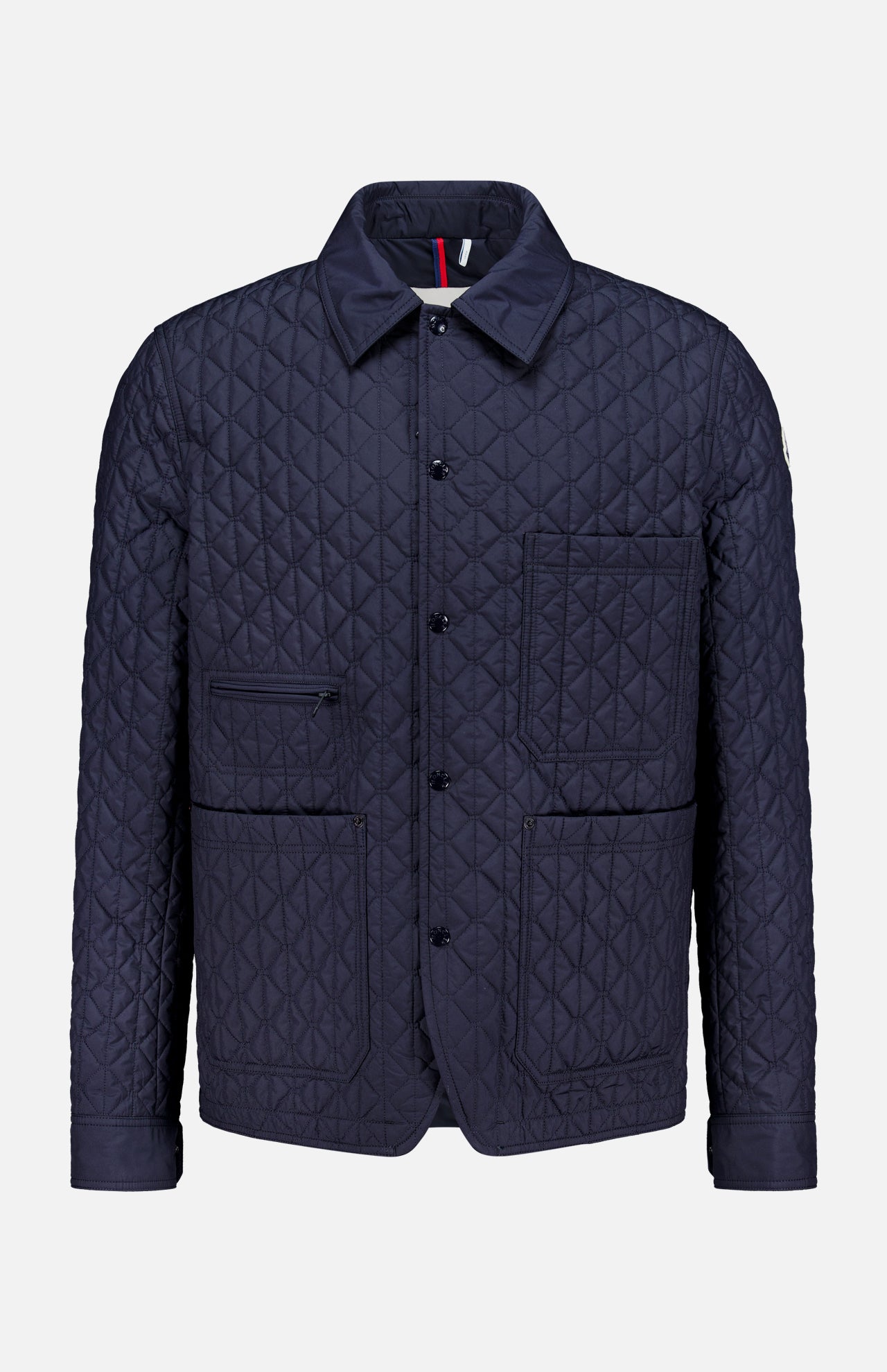 Theoline Quilted Overshirt by MONCLER features a navy quilted design with a pointed collar, button front, two chest pockets, and two hip pockets—a must-have for men’s outerwear.