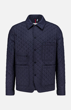 Theoline Quilted Overshirt by MONCLER features a navy quilted design with a pointed collar, button front, two chest pockets, and two hip pockets—a must-have for men’s outerwear.