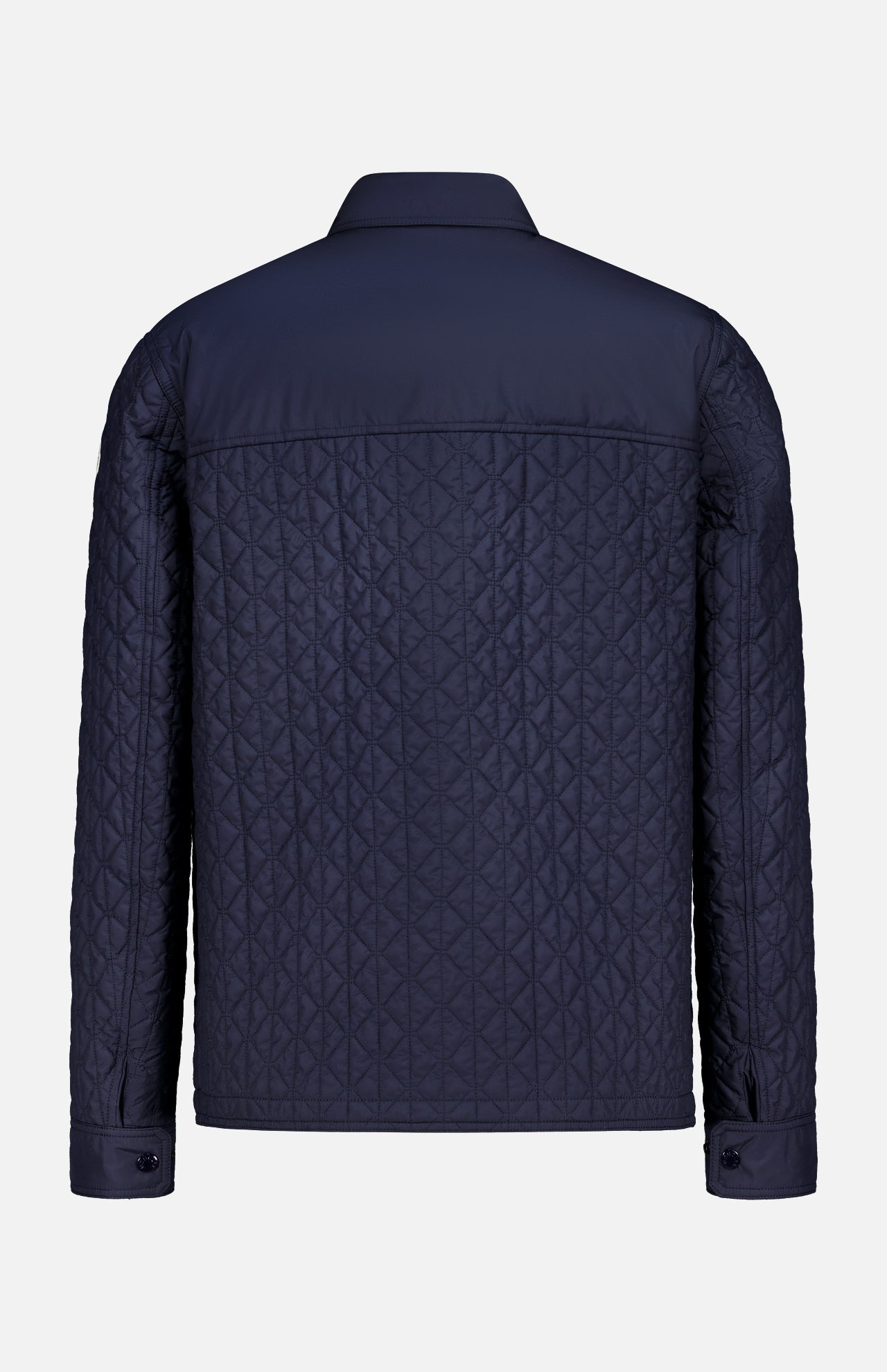 The MONCLER Theoline Quilted Overshirt in navy features a diamond-pattern stitch, long sleeves with buttoned cuffs, and a classic collar—an elegant men's outerwear option shown from the back.