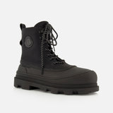 The Vera Sheal Ankle Boots by MONCLER feature a black lace-up design with a chunky sole, side logo patch, fleece interior, and patterned laces, shown against a plain white background.