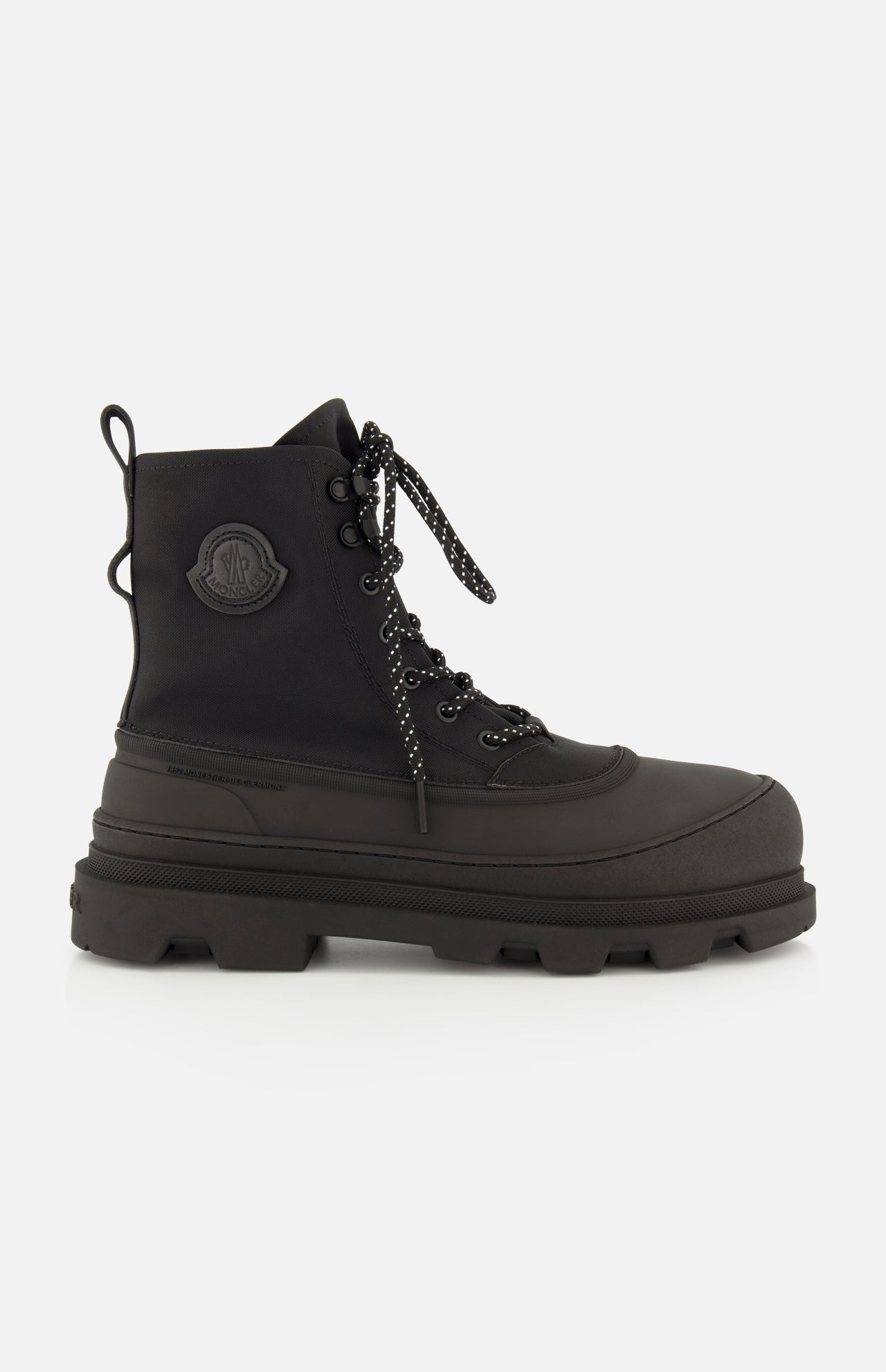 These Vera Sheal Ankle Boots by MONCLER feature black lace-up combat styling with a thick, chunky sole, a round toe, and the signature Moncler logo patch on the ankle. With a cozy fleece interior, these boots are the perfect blend of comfort and style for city living.