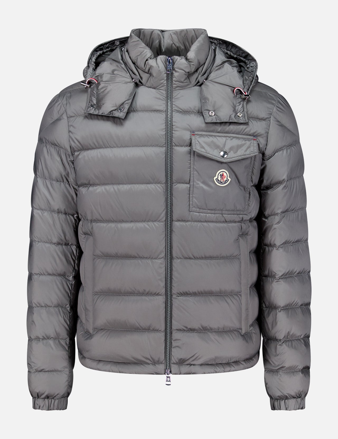 A gray MONCLER Verith Puffer Jacket with a front zipper, hood, chest pocket featuring a logo patch, and elastic cuffs is displayed on a plain white background. This lightweight down jacket offers added versatility and comfort with its removable hood.