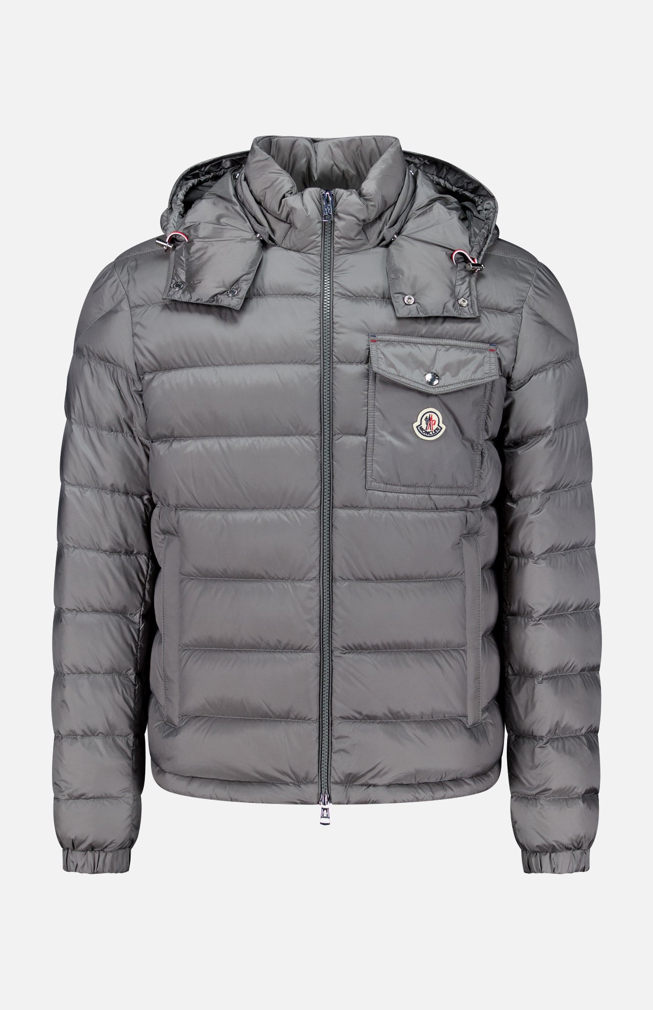 A gray MONCLER Verith Puffer Jacket with a front zipper, hood, chest pocket featuring a logo patch, and elastic cuffs is displayed on a plain white background. This lightweight down jacket offers added versatility and comfort with its removable hood.