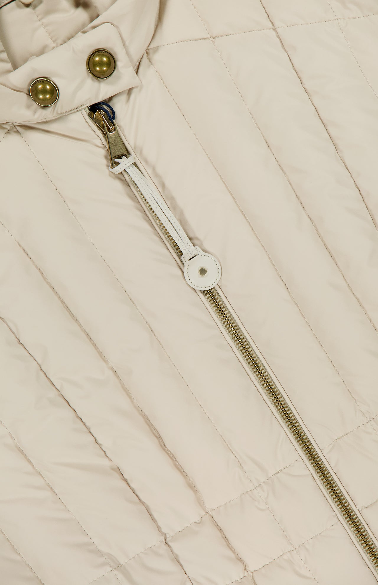 Close-up of the MONCLER Menthelong Long Down Filled Coat in beige, featuring vertical quilting, a gold zipper with white leather pull tab, two metallic snap buttons at the collar, and a detachable hood for added versatility.