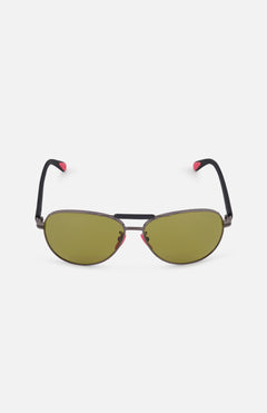 The MONCLER Steller Sunglasses feature green smoky lenses, black frames with a double bridge, and black arms tipped in pink—shown against a white background.